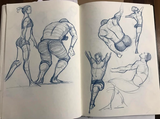 An open sketchbook spread of figures in motion, in blue pencil