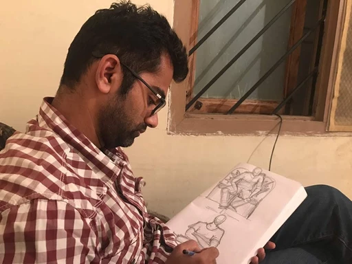 Cyril drawing figure studies in a sketchbook